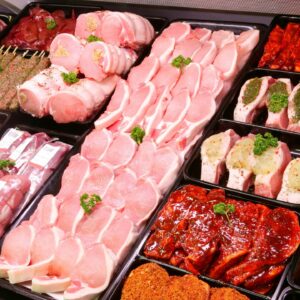 A bunch of different meats are in trays