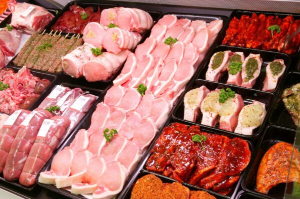 A bunch of different meats are in trays