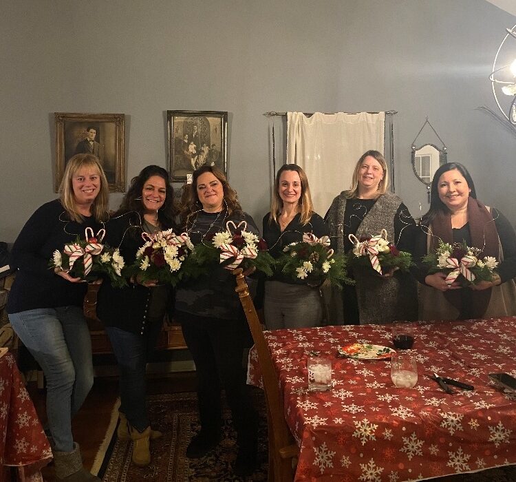 A group of women holding flowers in their hands.