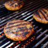 Grilled hamburger patties on a grill.