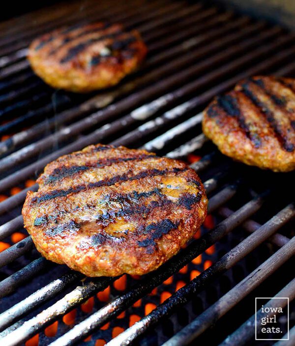 Grilled hamburger patties on a grill.